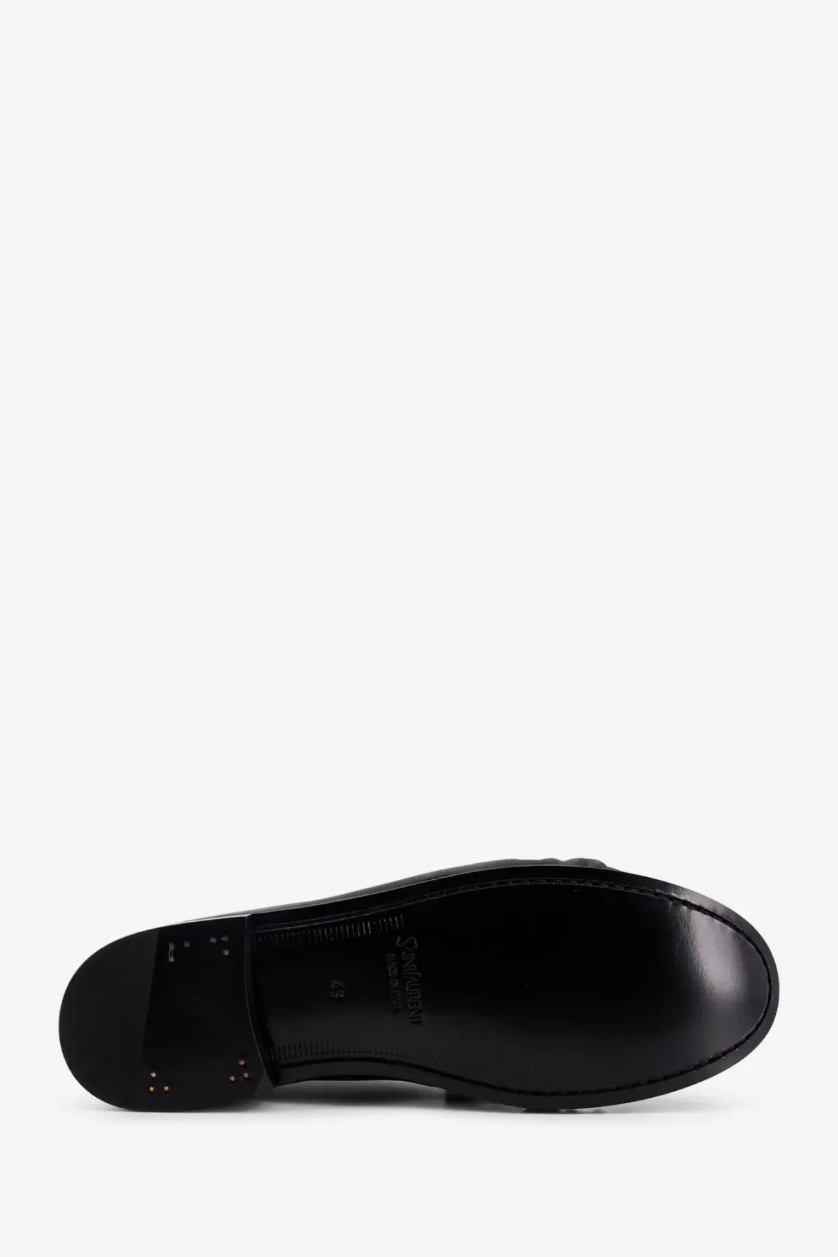 Black leather sole of saint laurent men’s le loafer with glossy finish and embossed branding visible