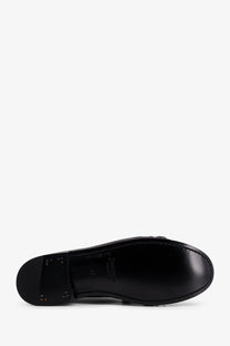 Black leather sole of saint laurent men’s le loafer with glossy finish and embossed branding visible