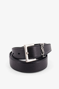 Saint Laurent men’s black leather belt with textured finish and silver-tone rectangular buckle featuring YSL logo