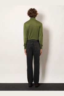 Olive green long-sleeved turtleneck shirt paired with saint laurent men’s black long mick denim trousers