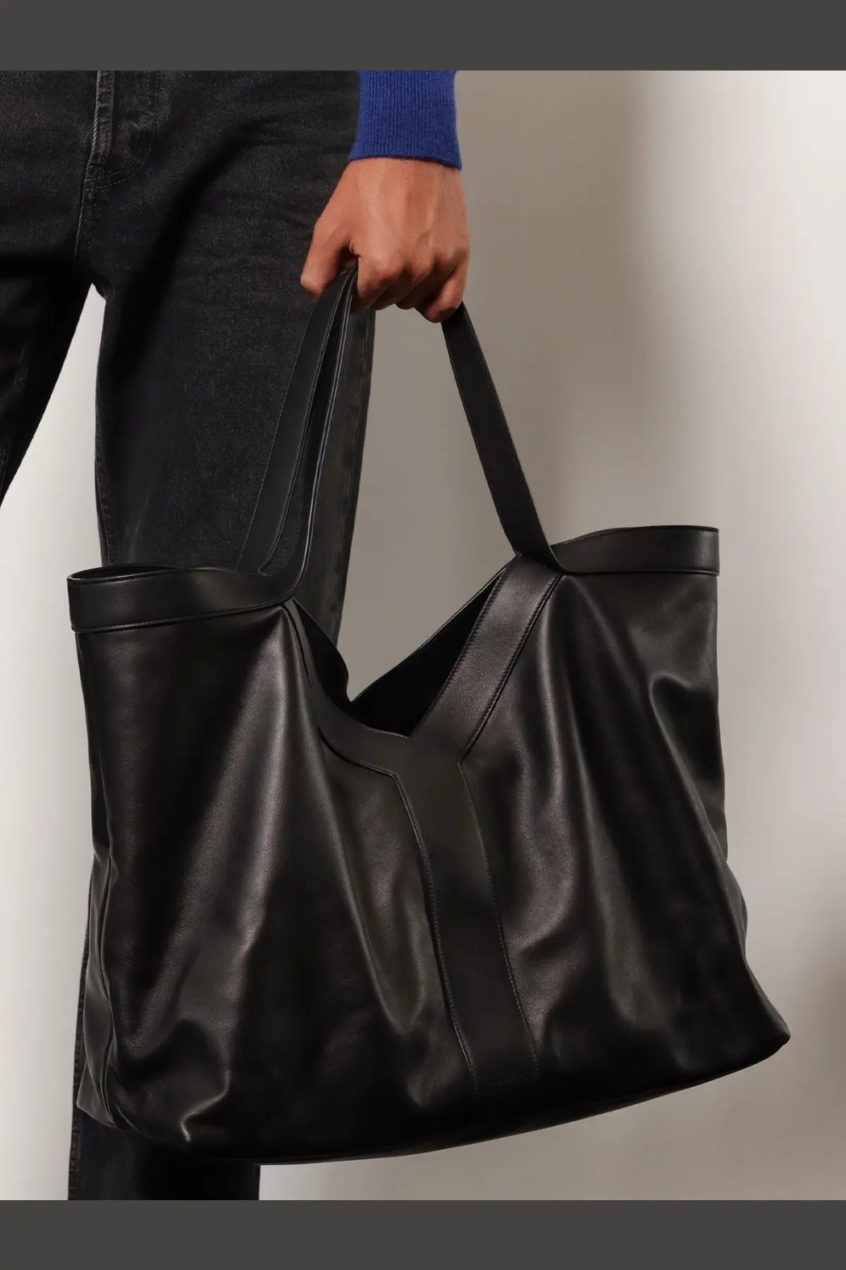 Saint laurent men’s oversize black leather tote bag with structured handles and minimalist design