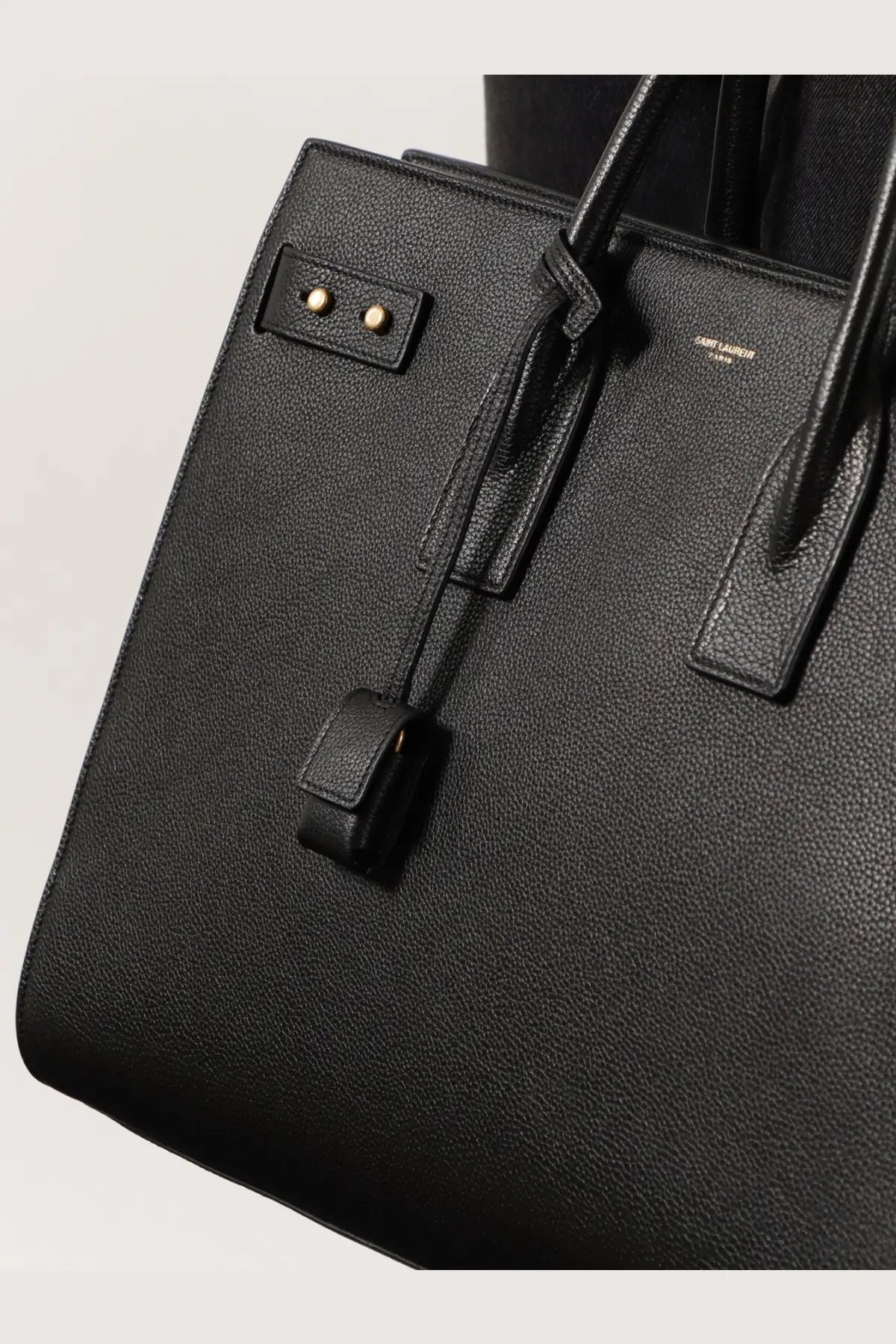 Saint Laurent men’s sac de jour large black leather shoulder bag with gold-tone hardware and textured surface