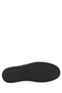 Black rubber sole with subtle embossed logo on saint laurent men’s smooth leather gym sneaker black