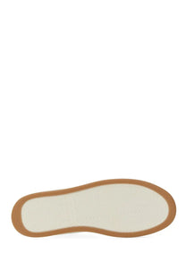 The insole of a saint laurent men’s sneaker sl white minimalist white leather shoe with a tan rubber sole