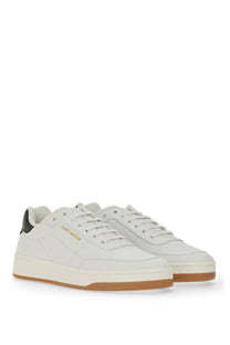 Saint Laurent men’s sneaker SL white white leather with tan rubber sole and black heel tab shown from the back