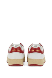 Back view of white and red saint laurent men’s sneakers with gold lettering on the heel in multicolor design