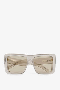 Saint Laurent women’s acetate sunglasses with clear rectangular frames beige tinted lenses and gold-tone branding on temples