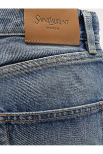 Saint Laurent women’s ankle midi blue denim jeans featuring a tan leather Saint Laurent Paris brand label on the back