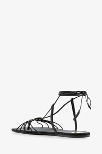 Saint Laurent women’s babylone black leather strappy sandal with decorative metallic clasp and adjustable ankle tie
