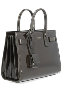 Saint Laurent women’s black patent leather sac de jour nano handbag with structured design and top handles