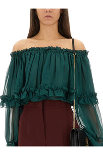 Saint Laurent women’s emerald green off-the-shoulder silk blouse with layered ruffles and sheer mesh sleeves