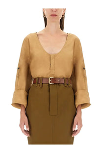 Tan belted Saint Laurent women’s blouse with rolled cuffs and v-neckline in beige for stylish casual wear