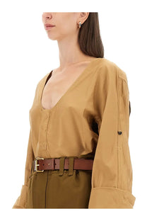Saint Laurent women’s blusa henley beige tan trench coat with deep v neck rolled up sleeves and subtle stitching details