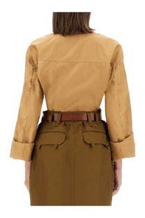 Saint Laurent women’s blusa henley beige with tan trench coat featuring rolled sleeves and brown leather belt