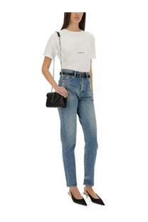 Black quilted leather crossbody bag with silver chain strap paired with Saint Laurent womens boyfriend shirt white