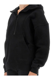 Saint Laurent women’s black hoodie with half-zip front and subtle embroidered logo on lower left side