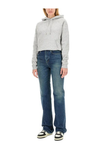 Saint laurent women’s grey hoodie paired with dark blue straight-leg denim jeans with faded wash and five-pocket design