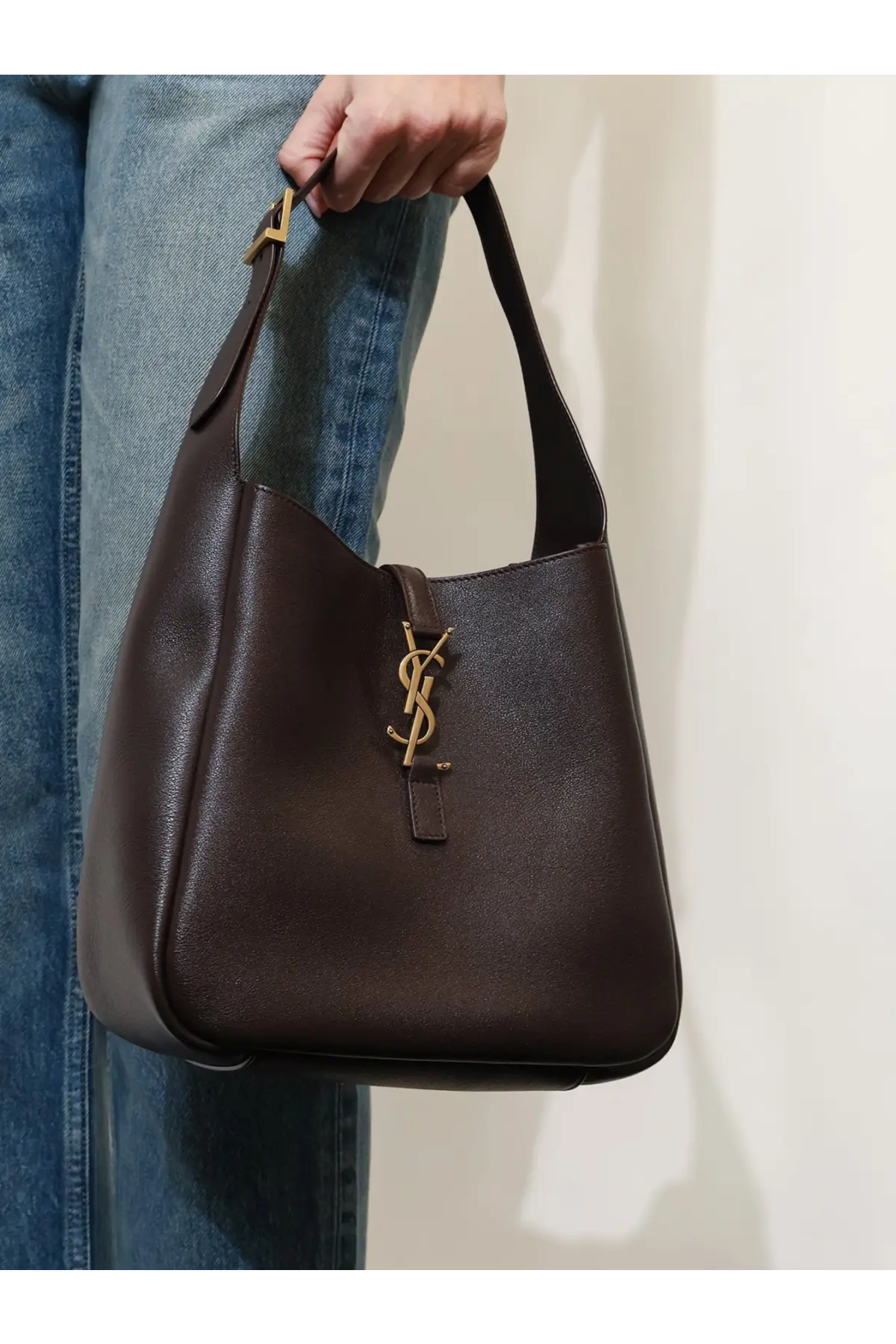 Dark brown leather Saint Laurent women’s le à shoulder bag with gold-tone YSL logo clasp and hobo design