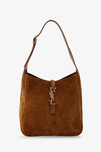 A tan suede saint laurent le à shoulder bag with a gold-tone ysl logo clasp in beige