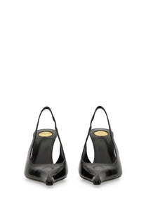 Saint Laurent women’s black patent leather slingback heels with pointed toe and gold-tone insole