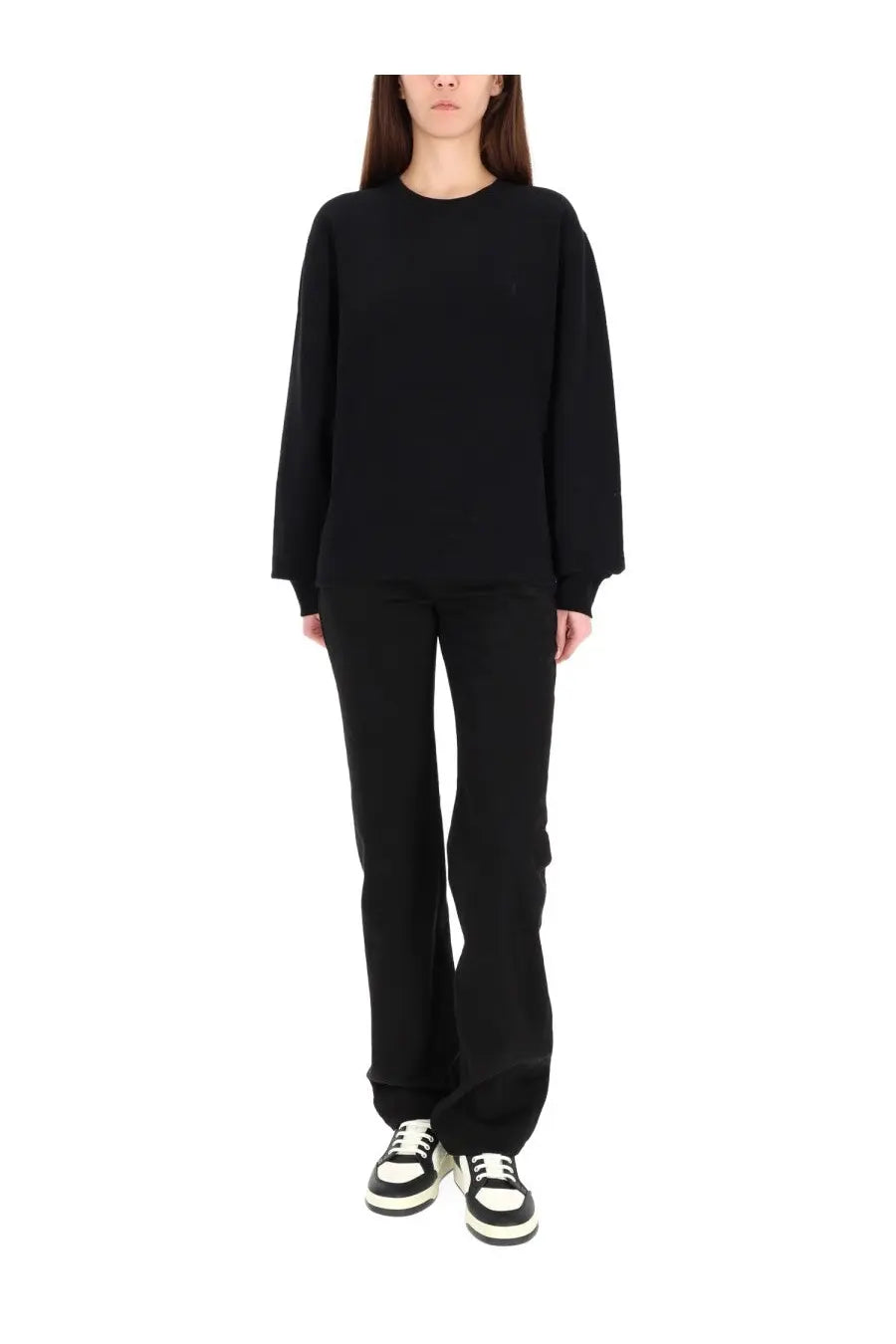 Black oversized crewneck sweatshirt with long sleeves and subtle logo paired with saint laurent women’s low waist jeans nicole black