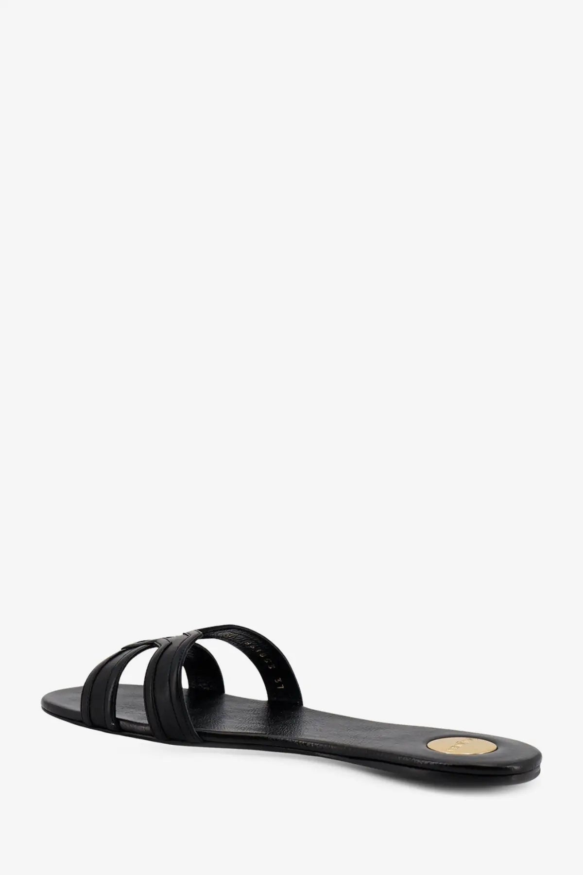 Saint Laurent women’s Mabrouka black leather slide sandal with minimalist design and gold-toned circular heel accent back view