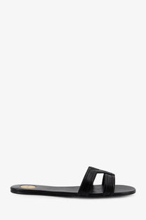 Saint Laurent women’s Mabrouka black leather slide sandal with minimalist design and rectangular strap detail
