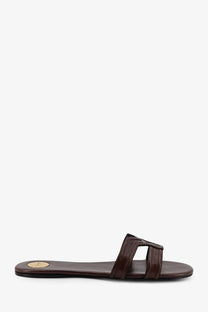 Saint Laurent women’s Mabrouka brown leather slide sandal with minimalist design and small gold logo on the insole