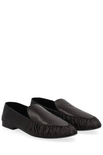 Saint Laurent women’s black leather moccasin loafers with ruched detail along the toe for stylish wear