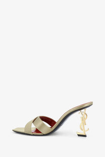 Beige satin strap mule sandal with gold-tone ysl logo heel from Saint Laurent women’s Opyum collection shown from the back
