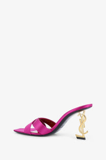 Saint Laurent women’s opyum satin mule sandal in fuchsia with a gold-tone YSL logo heel shown from the back side
