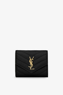 Saint Laurent women’s quilted leather wallet in black featuring a black quilted leather YSL card case with gold-tone logo
