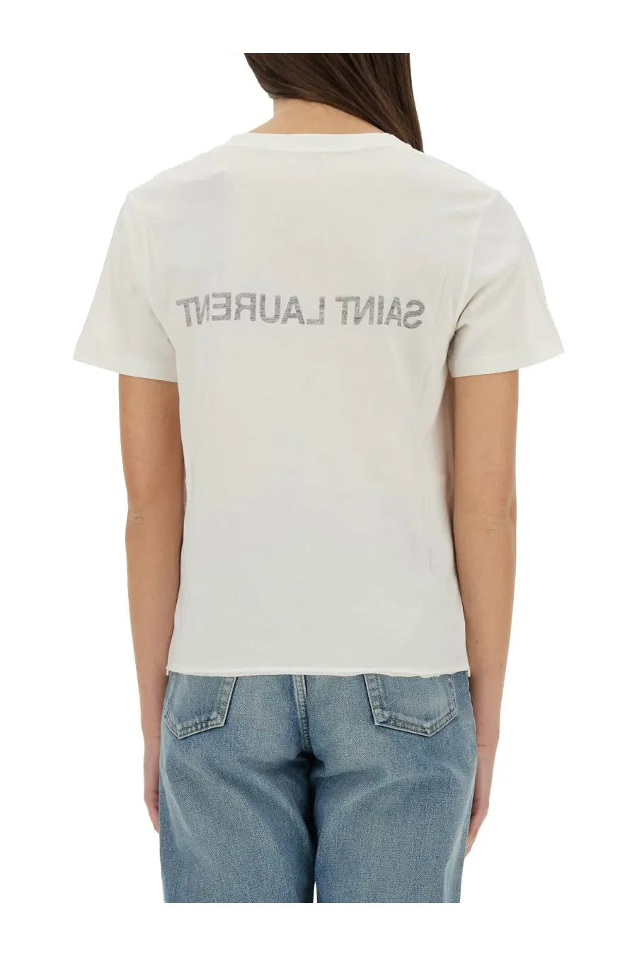 Back view of white saint laurent women’s t-shirt with silver lettering across the cotton fabric