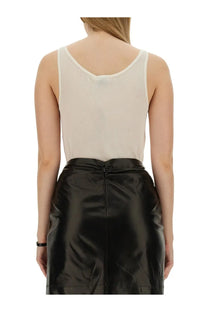 Saint laurent women’s beige round neckline tank top paired with sleek black patent leather high waist skirt back view