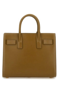 Tan leather saint laurent small bag shown in a saint laurent women’s sac de jour green product listing