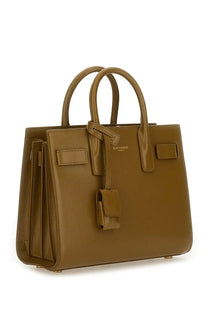 Tan leather saint laurent sac de jour handbag with structured design and top handles for women in green