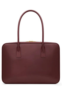 Saint Laurent women’s sac de jour bag in red burgundy leather with curved top handles and gold-tone zipper closure