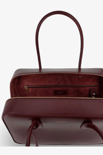 Saint Laurent women’s sac de jour leather tote bag in burgundy with structured rectangular shape and dual top handles