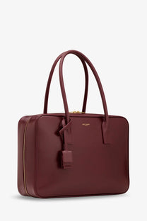 Saint Laurent women’s sac de jour tote bag in burgundy leather with gold hardware and minimalist design