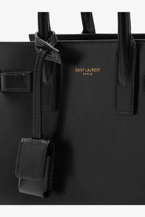 Saint Laurent women’s sac de jour nano black leather crossbody tote bag with gold-tone branding and structured handles