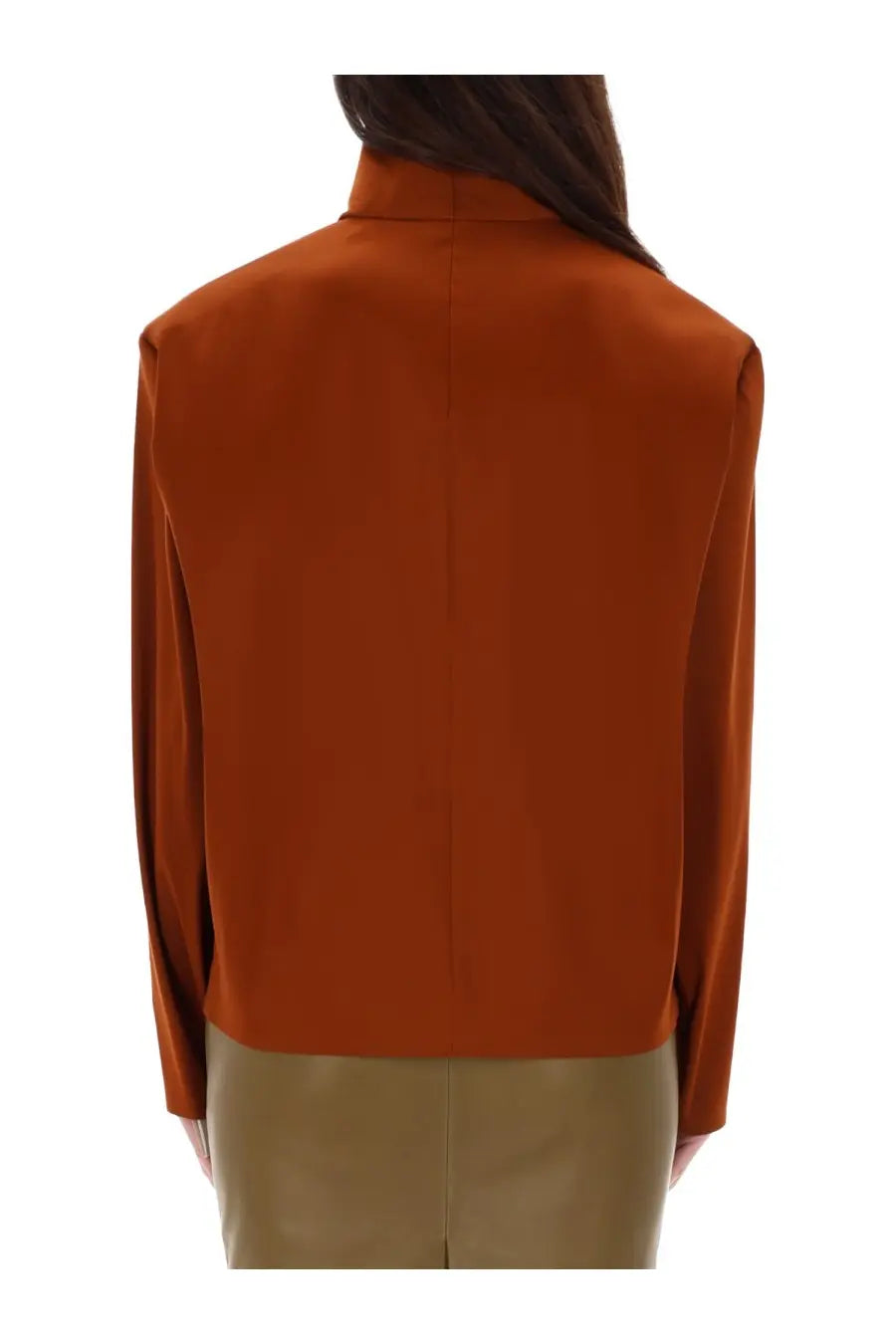 A sleek rust-orange silk blouse with high collar and long sleeves from Saint Laurent women’s collection