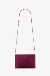 Saint Laurent women’s suede crossbody clutch in burgundy with gold-tone chain strap for elegant wear