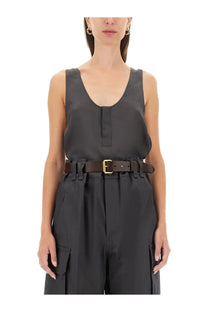 Black leather belt with gold-tone buckle and frayed edges paired with saint laurent women’s grey henley tank top