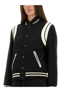 Black Saint Laurent women’s wool teddy varsity jacket with cream-colored stripes on shoulders sleeves and hem