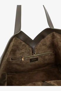 Saint Laurent women’s tote bag in green hammered leather with taupe suede lining, dark brown leather straps, and gold zipper