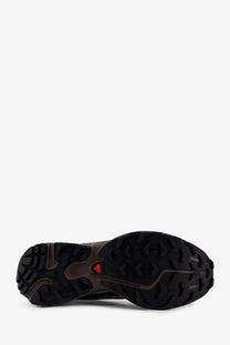 Back side of salomon men’s brown mesh sneakers with black rubber outsole and rugged tread with red triangular logo