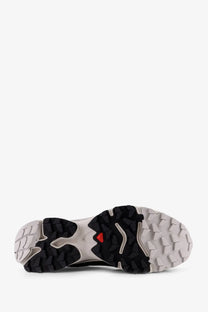 Back view of salomon men’s black nylon and goretex trail running shoe with rugged outsole and red salomon logo on heel