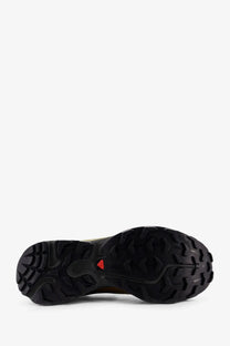 Back side of salomon men’s brown nylon sneakers showing black rubber outsole with aggressive tread and red logo on heel