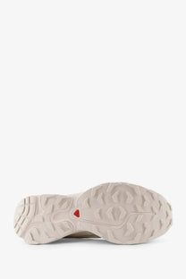 Beige salomon men’s nylon sneaker sole with red triangular logo for trail running and outdoor use