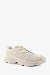 Cream-colored salomon men’s nylon sneakers with mesh upper and bold geometric overlays for running use
